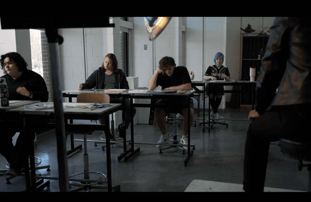 Students sit in a classroom in a screenshot from a film